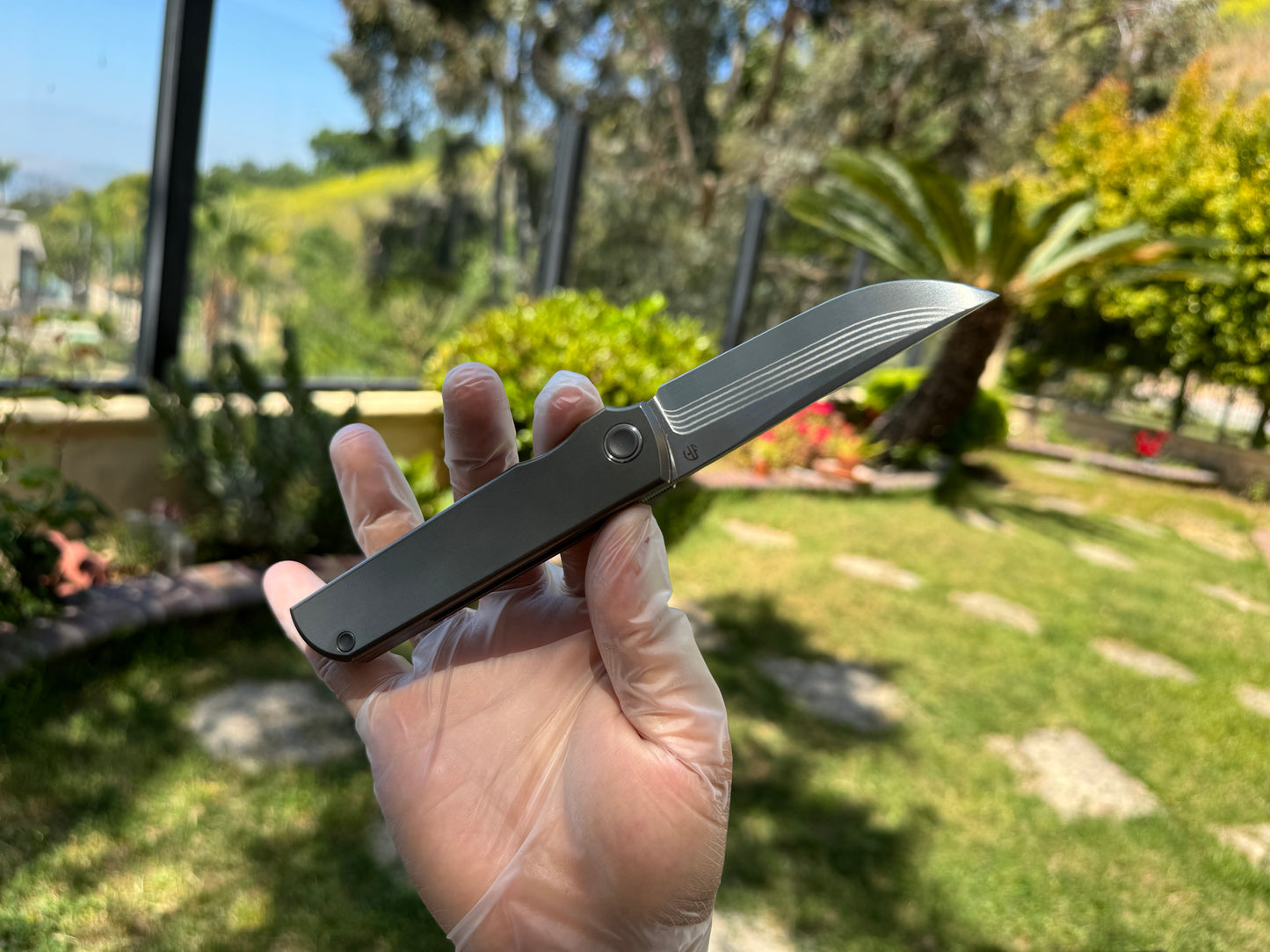 Salmon layered Damascus ZDP-189 core, titanium handle, titanium pocket clip, Japanese Kwaiken style