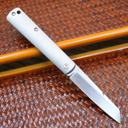 Production test Pocket knife with non-locking mechanism, titanium alloy handle, carbon fiber inlay, M390 hand-finished satin finish.