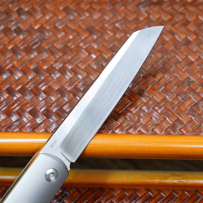 Production test Pocket knife with non-locking mechanism, titanium alloy handle, carbon fiber inlay, M390 hand-finished satin finish.