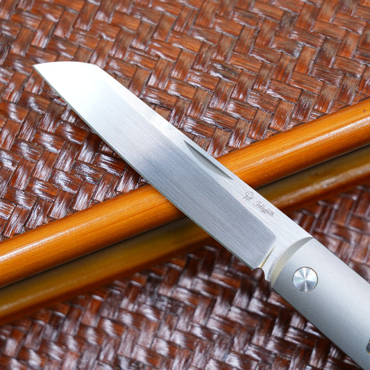 Production test Pocket knife with non-locking mechanism, titanium alloy handle, carbon fiber inlay, M390 hand-finished satin finish.