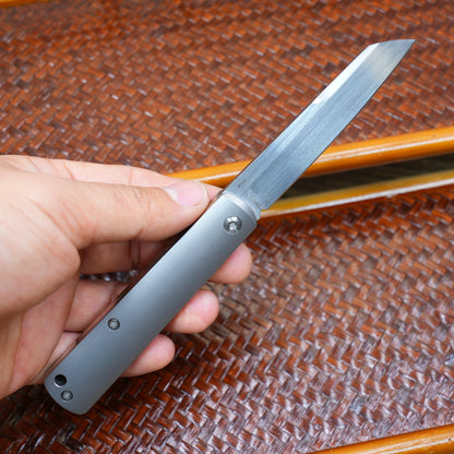 Production test Pocket knife with non-locking mechanism, titanium alloy handle, carbon fiber inlay, M390 hand-finished satin finish.