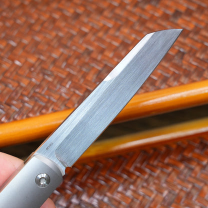 Production test Pocket knife with non-locking mechanism, titanium alloy handle, carbon fiber inlay, M390 hand-finished satin finish.