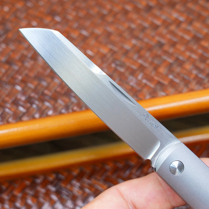 Production test Pocket knife with non-locking mechanism, titanium alloy handle, carbon fiber inlay, M390 hand-finished satin finish.