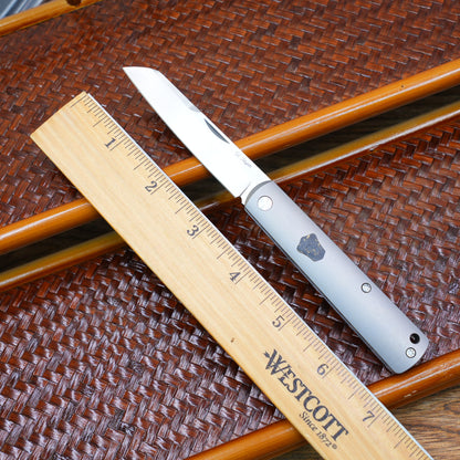 Production test Pocket knife with non-locking mechanism, titanium alloy handle, carbon fiber inlay, M390 hand-finished satin finish.