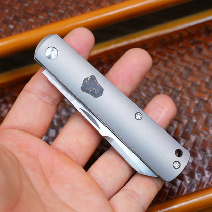 Production test Pocket knife with non-locking mechanism, titanium alloy handle, carbon fiber inlay, M390 hand-finished satin finish.