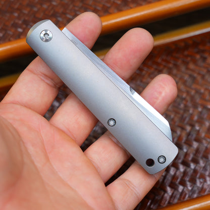 Production test Pocket knife with non-locking mechanism, titanium alloy handle, carbon fiber inlay, M390 hand-finished satin finish.